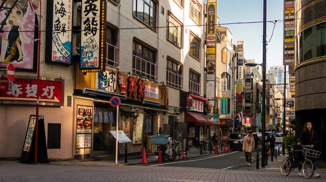 An image of a cafe on a cute but busy Japanese street