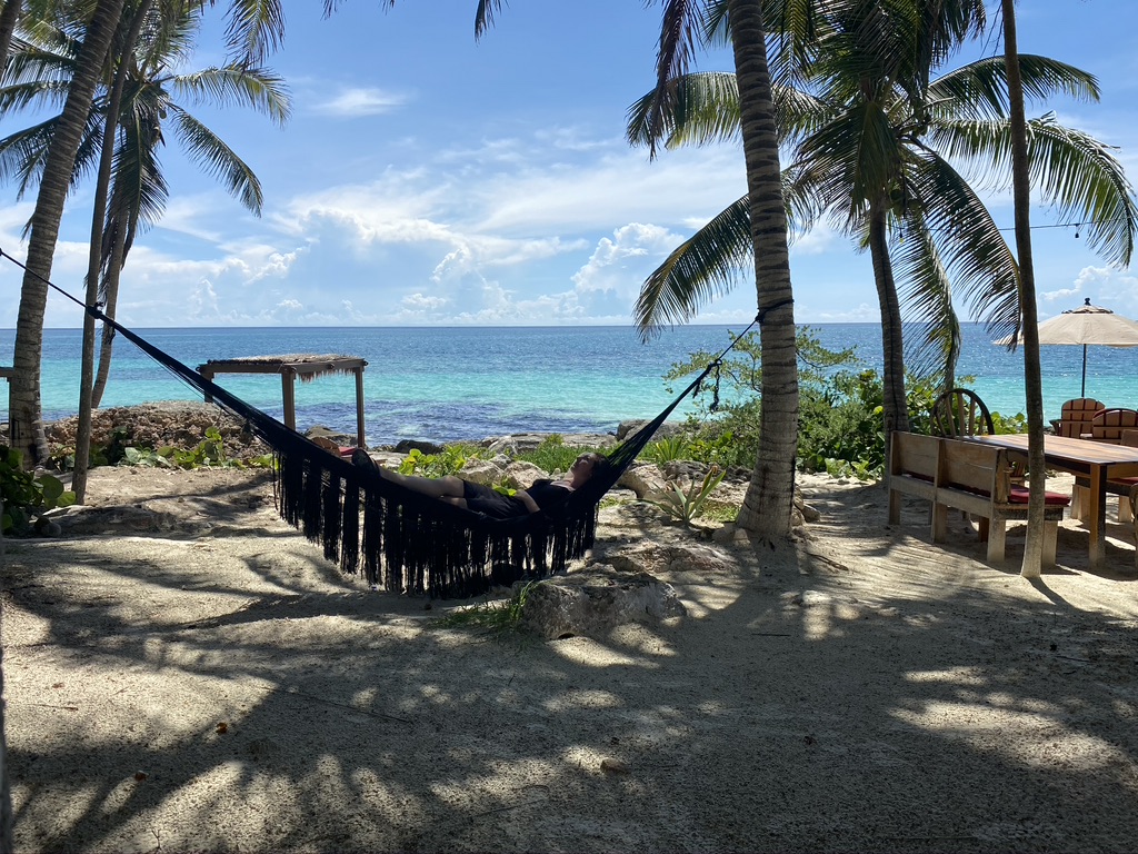 digital nomad itinerary - woman laying in hammock on the beach