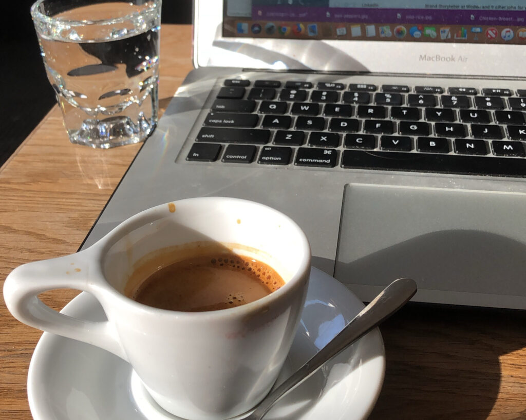 cafes in malta - cup of espresso next to computer keyboard