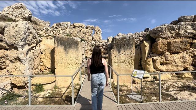 girl walking through ancient ruins at Ggantija Temple
