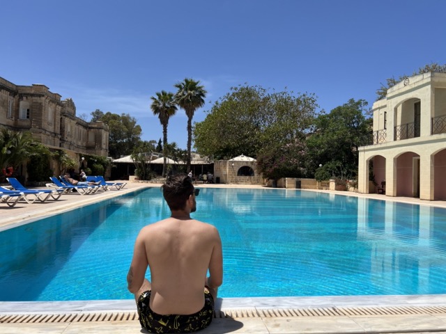man sitting by pool