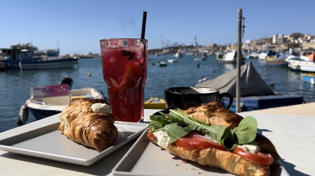 breakfast sandwich, croissant, coffee, and juice